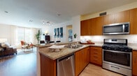 Located at 610 E Union St in Pasadena, California, this single-story residence offers a well-designed layout with modern finishes and a cohesive interior aesthetic throughout. The kitchen serves as a central highlight, featuring warm wood cabinetry, granite countertops, a peninsula with bar seating, and a full suite of stainless steel appliances including a gas range, built-in microwave, dishwasher, and refrigerator. Light wood-style flooring runs through the kitchen and connects seamlessly to the open dining and living areas. The dining area accommodates a full-sized table and benefits from direct access to the exterior, allowing natural light to fill the space. The bedrooms are generously proportioned, each with large windows that bring in ample daylight. One bedroom features a bold terracotta accent wall, adding warmth and character, while a second bedroom is finished in soft gray tones with outdoor views. The primary bath includes a vanity with wood cabinetry, a wide mirror, wood-style flooring, and a soaking tub. A spacious walk-in closet provides abundant storage with built-in shelving and hanging rods. The overall ambiance is clean, contemporary, and inviting.