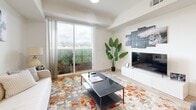 Located at 900 N Ardmore Ave in Los Angeles, this modern 2-bedroom, 2-bathroom residence offers a thoughtfully designed single-floor layout with clean lines and contemporary finishes throughout. Light wood-style flooring flows seamlessly across the open-concept living, dining, and kitchen area, creating a cohesive and airy atmosphere. The kitchen is well-appointed with stainless steel appliances including a refrigerator, range, microwave, and dishwasher, complemented by two-tone cabinetry featuring warm wood uppers and crisp white lower cabinets, set against light countertops. A conveniently tucked in-unit stacked washer and dryer adds everyday functionality. The living area is bright and welcoming, anchored by a large sliding glass door that opens to a private balcony with scenic views of the surrounding Los Angeles hills. Both bedrooms are comfortably sized, featuring light-filled windows, sliding closet doors, and a clean, neutral palette. The primary bedroom benefits from natural light on multiple sides. The two bathrooms offer distinct designs — one featuring a full soaking tub with shower, and the other a streamlined wall-mounted sink with a modern vanity mirror. Recessed lighting and a hallway connecting the key spaces complete this well-organized, contemporary residence in the heart of East Hollywood.