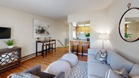 Located at #509 5054 Justin Terr in Fremont, CA, this two-story, one-bedroom, one-bathroom home offers a well-organized layout spread across two levels. The main level serves as the heart of the home, featuring a bright, open-concept living and kitchen area finished with warm hardwood flooring throughout. The living room is generously sized with a large sliding glass door that invites natural light and provides access to a private balcony with outdoor views. The kitchen is efficiently designed in a galley style, equipped with light wood cabinetry, a skylight overhead, a full suite of appliances including a range and refrigerator, and ample counter space. A staircase connects the main living area to the upper level, which houses the spacious primary bedroom. The bedroom is a comfortable retreat featuring hardwood floors, a mirrored sliding-door closet, its own private balcony access, and soft natural light. The full bathroom is well-appointed with a combined tub and shower enclosed by frosted glass sliding doors, a single vanity with stone-look countertop, and tile flooring. A hallway on the upper level provides a smooth transition between the bedroom and bathroom, completing this thoughtfully laid-out home.