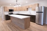 This single-story residence offers 1220 square feet of thoughtfully designed living space. The home boasts four bedrooms, including a 140 square foot primary bedroom, and two full bathrooms. The heart of the home is a stunning, renovated kitchen featuring light wood cabinetry, sleek white countertops, and stainless steel appliances. A subway tile backsplash adds a touch of contemporary style. The open concept living area seamlessly connects to the kitchen, creating an ideal space for entertaining.

Throughout the home, beautiful hardwood floors and neutral-toned walls create a bright, airy atmosphere. Large windows in the bedrooms and living areas allow natural light to flood the space. The bathrooms are equipped with modern fixtures, including a shower/tub combination with a curved curtain rod for added space.

Practicality meets convenience with an in-unit laundry room, complete with full-sized washer and dryer. Ample closet space in the bedrooms provides plenty of storage options. The home's layout, as seen in the 3D floor plan, ensures a smooth flow between rooms, maximizing the use of space. With its blend of modern amenities and thoughtful design, this home offers comfortable, contemporary living.