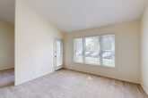 Located at 6201 Cedar Crest Dr in Johnston, Iowa, this single-floor unit offers an efficiently designed layout that makes excellent use of its compact footprint. The combined kitchen and living area forms the heart of the space, creating an open, connected atmosphere. The living area is finished with soft wall-to-wall carpeting and features a large triple-pane window that floods the room with natural light while offering pleasant outdoor views of the surrounding greenery. A private exterior door in the living area provides convenient direct access to the outside. The kitchen is thoughtfully laid out with a peninsula/breakfast bar that defines the space without closing it off. White cabinetry with warm wood-toned accents lines the walls, complemented by light countertops, a built-in dishwasher, refrigerator, electric range, and overhead microwave. Tile flooring in the kitchen adds a practical, easy-to-clean surface. A full bathroom is accessible from the interior hallway and features a vanity with storage. Throughout the unit, neutral cream-toned walls and consistent finishes create a clean, cohesive aesthetic. Louvered closet doors provide additional storage, rounding out the functional and straightforward design of this Johnston residence.
