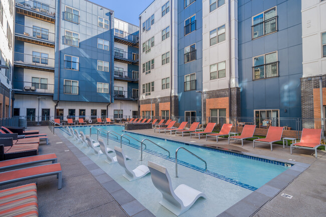 Relax and unwind in this stylish outdoor space, complete with a refreshing pool and comfortable sun loungers. - Eastside Heights