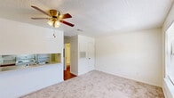 Located at 994 S Kenilworth Pkwy in Baton Rouge, Louisiana, this one-bedroom, one-bathroom unit offers a practical and comfortable single-floor layout. The galley-style kitchen is equipped with warm wood cabinetry, a double-basin stainless steel sink, a white range, a dishwasher, and a full-size refrigerator, all set atop durable hardwood-style flooring. A pass-through counter connects the kitchen to the living area, enhancing the open feel of the space. The living area features carpet flooring and a window that invites natural light and views of surrounding greenery, complemented by a ceiling fan with integrated lighting. The bedroom continues the carpeted flooring and includes a mirrored sliding closet, a ceiling fan with light fixture, and a textured ceiling, contributing to a bright and airy feel. The bathroom is finished with hardwood-style flooring, a single-sink vanity with wood cabinetry, a mirrored medicine cabinet with overhead lighting, and a shower-tub combination. Textured walls throughout the unit add a subtle design element, while the overall layout prioritizes efficient use of space in a well-organized, functional floor plan.