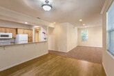 Located at 604 S Fair Oaks Ave in Sunnyvale, CA, this single-story home offers four bedrooms, two bathrooms, and a well-designed open layout that maximizes functionality. The combined kitchen and living area serves as the heart of the home, where warm hardwood flooring flows from the kitchen into the dining space, transitioning seamlessly to plush carpeting in the living room. The kitchen is equipped with light wood cabinetry, granite-style countertops, a double stainless steel sink, and white appliances including a refrigerator, range, and dishwasher. Recessed lighting and crown molding throughout lend a clean, polished finish to the interiors. The spacious living room benefits from multiple windows that invite natural light and offer views of surrounding greenery. The generous primary bedroom features large windows, recessed lighting, crown molding, and plush carpet. Additional bedrooms are well-proportioned with ample closet space, including sliding-door closets with built-in hanging rods. Both bathrooms are appointed with granite-style surround tub-shower combos, tile flooring, and wood-trimmed vanities. A dedicated laundry room provides added convenience with washer and dryer included. The home's bright, neutral palette creates a welcoming and versatile living environment.