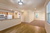 Located at 604 S Fair Oaks Ave in Sunnyvale, CA, this single-story home offers four bedrooms, two bathrooms, and a well-designed open layout that maximizes functionality. The combined kitchen and living area serves as the heart of the home, where warm hardwood flooring flows from the kitchen into the dining space, transitioning seamlessly to plush carpeting in the living room. The kitchen is equipped with light wood cabinetry, granite-style countertops, a double stainless steel sink, and white appliances including a refrigerator, range, and dishwasher. Recessed lighting and crown molding throughout lend a clean, polished finish to the interiors. The spacious living room benefits from multiple windows that invite natural light and offer views of surrounding greenery. The generous primary bedroom features large windows, recessed lighting, crown molding, and plush carpet. Additional bedrooms are well-proportioned with ample closet space, including sliding-door closets with built-in hanging rods. Both bathrooms are appointed with granite-style surround tub-shower combos, tile flooring, and wood-trimmed vanities. A dedicated laundry room provides added convenience with washer and dryer included. The home's bright, neutral palette creates a welcoming and versatile living environment.