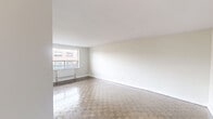 Located on the fourth floor at 2220 Weston Road in Toronto's Weston neighbourhood, this one-bedroom, one-bathroom unit offers a well-organized layout across a single floor. The open living and dining area is generously proportioned, featuring classic parquet wood flooring and neutral white walls that create a bright, clean aesthetic. Large windows invite abundant natural light and frame views of the surrounding urban streetscape, while access to a balcony further extends the sense of space.

The kitchen is efficiently designed with white cabinetry, dark countertops, and a full suite of stainless steel appliances including a refrigerator, electric range, and built-in microwave. Tile flooring in the kitchen transitions seamlessly into the parquet of the living area.

The bedroom is a comfortable, well-lit room with a window featuring a radiator beneath it, overlooking the neighbourhood. Parquet flooring carries through from the main living areas, maintaining a consistent feel throughout.

The bathroom is finished with classic white subway tile in the tub surround, complemented by a dark wood vanity with a white basin, a large mirror, and tile flooring, giving it a timeless and clean character. Overall, the unit presents a bright, practical, and well-maintained living space in a residential Toronto community.