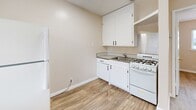 Located at 1180 Saranap Ave in Walnut Creek, CA, this one-bedroom unit offers a well-organized and efficiently designed single-floor layout. Light wood-style flooring runs consistently throughout the space, contributing to a clean, cohesive aesthetic.

The living area greets you at the entrance, which features a classic paneled door with a transom window above, allowing natural light into the space. A large window with blinds adds further brightness and provides views of the surrounding neighborhood.

The kitchen is compact yet functional, outfitted with white cabinetry — both upper and lower — a stainless steel sink, a gas range, and a refrigerator. The dark countertops provide a subtle contrast to the white finishes, creating a tidy and practical cooking space.

The bedroom is a comfortable size, featuring a ceiling fan with a light fixture and a generously sized window that brings in ample natural light and outdoor views of the surrounding greenery. Adjacent to the bedroom is a dedicated closet with shelving and a full bathroom equipped with a stand-up shower.

Warm, neutral-toned walls throughout the unit lend a welcoming ambiance, while the clean, move-in-ready condition makes this an easily adaptable space for a variety of living arrangements.