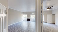Located on White Oak Ave in the desirable Encino neighborhood of Los Angeles, this single-story home offers a well-planned layout with a cohesive neutral palette and updated finishes throughout. The spacious living room is a standout feature, showcasing light wood-style flooring, crown molding, a classic fireplace, and a row of large windows with elegant arched transoms that fill the space with abundant natural light. An adjacent area connects seamlessly to the kitchen via a raised bar counter, offering an open and functional flow. The kitchen is well-appointed with gray shaker-style cabinetry, light quartz countertops, a subway tile backsplash, and a full suite of stainless steel appliances including a gas range, microwave, and dishwasher. The bedrooms feature plush carpeting, ceiling fans, crown molding, and generous closet space, including mirrored sliding doors in one room. Each bedroom benefits from natural light through arched and grid-style windows. The bathrooms are finished with light quartz vanity countertops, large mirrors, and glass-enclosed shower and tub combinations. Overall, the home presents a clean, move-in-ready environment with classic architectural details and practical modern updates.