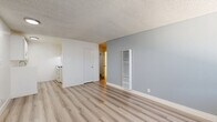 Located at 17341 Hurley St in La Puente, CA, this single-story, one-bedroom, one-bathroom unit offers a well-organized layout designed to maximize every square foot. Light-toned luxury vinyl plank flooring runs throughout the entire space, creating a clean, cohesive aesthetic that reflects natural light effectively.

The combined living and dining area serves as the heart of the unit, featuring soft blue-gray accent walls, a textured ceiling, a wall-mounted HVAC vent, and a large window fitted with blinds that allows abundant natural light to fill the room. The adjacent kitchen is positioned for convenient access and includes a gas range and white cabinetry.

A hallway connects the main living space to the private areas of the unit, including the bedroom and bathroom. The bedroom is a comfortable size, equipped with a ceiling fan, a built-in closet with bi-fold doors, and a window with blinds that brings in natural light. Three closets total are distributed throughout the unit, providing generous storage capacity.

The bathroom is clean and functional, featuring a white vanity with cabinet storage, a mirrored medicine cabinet, a soaking tub, and accessibility-friendly grab bars. Consistent LVP flooring extends into this space as well, tying the overall design together with a uniform, modern finish.