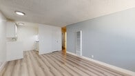 Located at 17341 Hurley St in La Puente, CA, this single-story, one-bedroom, one-bathroom unit offers a well-organized layout designed to maximize every square foot. Light-toned luxury vinyl plank flooring runs throughout the entire space, creating a clean, cohesive aesthetic that reflects natural light effectively.

The combined living and dining area serves as the heart of the unit, featuring soft blue-gray accent walls, a textured ceiling, a wall-mounted HVAC vent, and a large window fitted with blinds that allows abundant natural light to fill the room. The adjacent kitchen is positioned for convenient access and includes a gas range and white cabinetry.

A hallway connects the main living space to the private areas of the unit, including the bedroom and bathroom. The bedroom is a comfortable size, equipped with a ceiling fan, a built-in closet with bi-fold doors, and a window with blinds that brings in natural light. Three closets total are distributed throughout the unit, providing generous storage capacity.

The bathroom is clean and functional, featuring a white vanity with cabinet storage, a mirrored medicine cabinet, a soaking tub, and accessibility-friendly grab bars. Consistent LVP flooring extends into this space as well, tying the overall design together with a uniform, modern finish.