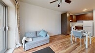 Located at 60 Avenue des Pins Ouest in Montréal's vibrant Plateau-Mont-Royal neighborhood, this studio unit offers a well-organized, efficient layout across a single floor. The open-concept living space features warm hardwood flooring throughout, clean white walls, and a ceiling fan that enhances airflow and comfort. A large sliding glass door floods the living area with natural light and provides direct access to a balcony with views of the lush, tree-lined streetscape below.

The living area flows seamlessly into a compact dining nook and kitchenette. The kitchen is equipped with warm wood cabinetry, a full-size refrigerator, and a sink, offering all the essentials within an efficient footprint. Light tile flooring defines the kitchen and transition zone, creating a visual distinction from the main living space.

The bathroom is accessible from the main living area and features light ceramic tile flooring, a full soaking bathtub with an overhead shower, a pedestal sink, and crisp white walls that give the space a clean, functional feel.

This studio is thoughtfully laid out to maximize every square meter, making it a practical and comfortable option for those seeking a well-located residence in one of Montréal's most walkable and dynamic urban neighborhoods.