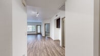Located in the Curtis Park neighborhood of Sacramento, CA, this one-bedroom, one-bathroom unit offers a well-designed layout across a single floor. The open living area greets you with warm hardwood-style flooring, crisp white walls, and ample natural light streaming through large windows fitted with blinds. A hallway connects the main living spaces seamlessly, lending the unit a clean, functional flow.

The kitchen is a standout feature, equipped with rich dark-brown cabinetry, white quartz countertops, a classic subway tile backsplash, and a full suite of stainless steel appliances including a refrigerator, range, microwave, and dishwasher. Recessed lighting illuminates the space, adding a modern touch.

The bedroom is a comfortable retreat finished with plush carpeting, a window with natural views, and direct access to a generously sized walk-in closet outfitted with multiple hanging rods and shelving. The bathroom is tastefully appointed with a dark-wood vanity, white countertop, a large mirror, built-in shelving, and a full soaking tub with shower combination. Hardwood-style flooring carries through this space as well, tying the unit together with a cohesive, contemporary aesthetic.