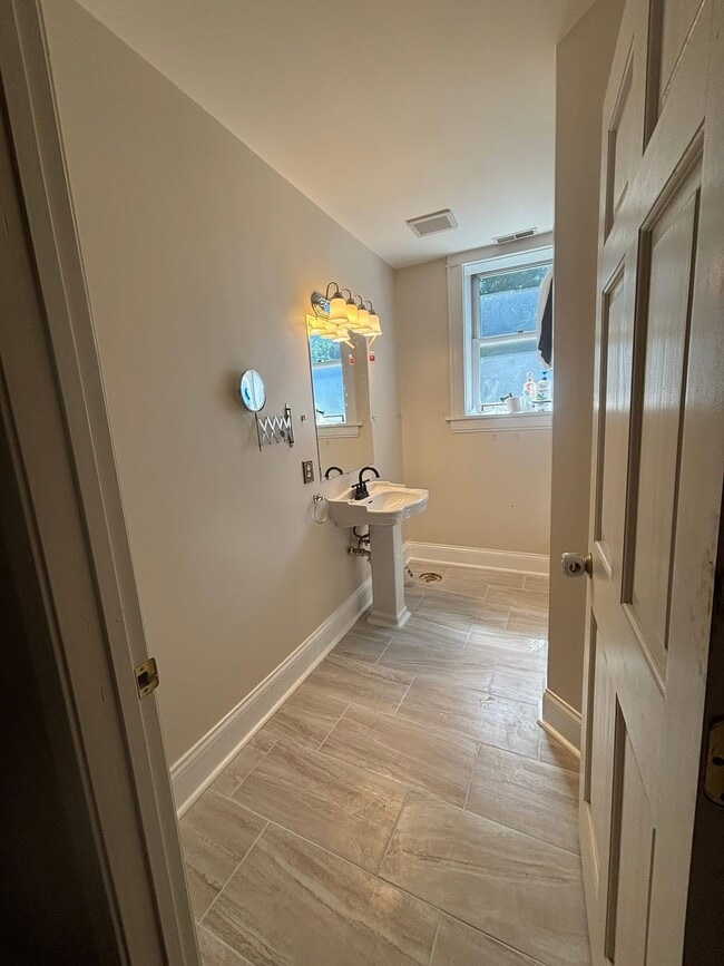 This the bathroom currently. There is a toilet the tile wasn’t dry yet. - 2056 Lafayette Ave