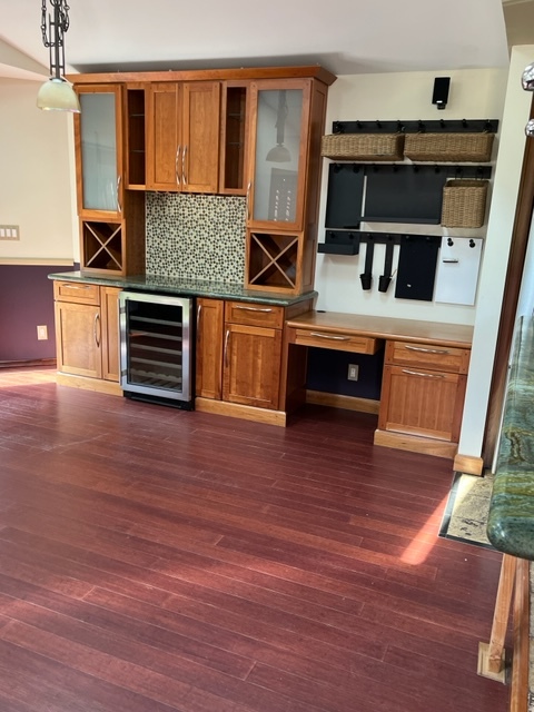Open layout living space with vaulted ceilings and built in hutch, desk and wine fridge - 1643 N Hoover St