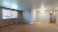 Located at 2356 N Limestone St in Springfield, Ohio, this single-floor residence offers a practical and straightforward layout designed for comfortable everyday living. The living area is generously sized, featuring neutral-toned carpet flooring and soft gray walls that create a calm, understated ambiance. A ceiling fan provides added comfort, while a window allows natural light to fill the space. The open flow between the living area and the kitchen makes the layout feel connected and functional. The kitchen is equipped with white cabinetry offering ample storage, light-toned countertops, a stainless steel sink, and a dishwasher. Wood-look flooring in the kitchen adds a warm contrast to the rest of the home. The bedroom is a comfortable retreat with carpeted flooring, a window with blinds for natural light and privacy, and a mirrored sliding closet that enhances the sense of space. An entry area with a mirrored closet provides additional storage and a welcoming transition into the home. The bathroom features a full tub and shower combination, wood-look flooring, white fixtures, and a vanity with storage, presenting a clean and functional design throughout.