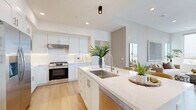Located at 123 S Chapel Ave in Alhambra, CA, this well-appointed 3-bedroom, 2-bathroom residence offers a thoughtfully designed single-floor layout with a bright, modern aesthetic throughout. Light wood flooring flows seamlessly across the entire space, anchoring a clean, cohesive interior palette of warm whites and soft neutrals.

The open-concept kitchen and living area serves as the heart of the home. The kitchen features white shaker cabinetry, quartz countertops, stainless steel appliances including a gas range and built-in microwave, and a central island with bar seating — ideal for both everyday living and entertaining. The adjacent living room is bathed in natural light from large corner windows that frame panoramic views of the surrounding cityscape and greenery.

The primary bedroom is generously proportioned, with tall windows offering elevated outdoor views and a serene, airy atmosphere. A second bedroom opens directly onto a private balcony, extending the living space outdoors. The third bedroom is equally well-lit and comfortable. The primary bathroom is a standout, featuring marble-style tile, a soaking tub, a separate glass-enclosed shower, and white cabinetry with a dark quartz vanity. The second bathroom offers a clean, minimalist walk-in shower with wood-look flooring. A dedicated hallway and closet complete the functional layout.