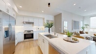 Located at 123 S Chapel Ave in Alhambra, CA, this well-appointed 3-bedroom, 2-bathroom residence offers a thoughtfully designed single-floor layout with a bright, modern aesthetic throughout. Light wood flooring flows seamlessly across the entire space, anchoring a clean, cohesive interior palette of warm whites and soft neutrals.

The open-concept kitchen and living area serves as the heart of the home. The kitchen features white shaker cabinetry, quartz countertops, stainless steel appliances including a gas range and built-in microwave, and a central island with bar seating — ideal for both everyday living and entertaining. The adjacent living room is bathed in natural light from large corner windows that frame panoramic views of the surrounding cityscape and greenery.

The primary bedroom is generously proportioned, with tall windows offering elevated outdoor views and a serene, airy atmosphere. A second bedroom opens directly onto a private balcony, extending the living space outdoors. The third bedroom is equally well-lit and comfortable. The primary bathroom is a standout, featuring marble-style tile, a soaking tub, a separate glass-enclosed shower, and white cabinetry with a dark quartz vanity. The second bathroom offers a clean, minimalist walk-in shower with wood-look flooring. A dedicated hallway and closet complete the functional layout.