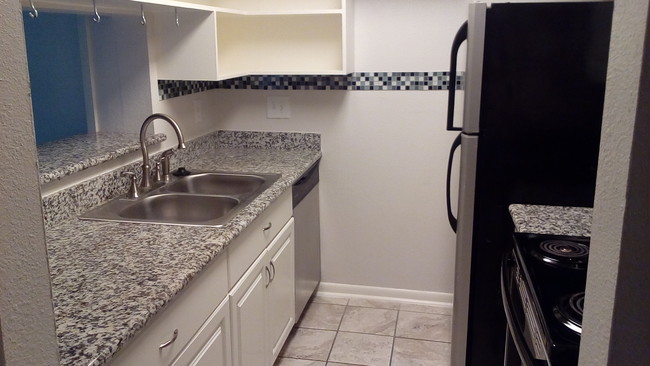 Kitchen boasts SS sink, range, over the range microwave and and dishwasher. Refrigerator included. - 8435 Hearth Dr