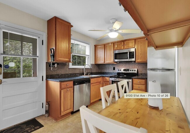 Kitchen and dining table - 9100 51st Ave