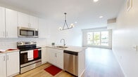 This well-designed one-bedroom, one-bathroom unit at 4021 Coon Rapids Blvd NW offers a thoughtfully arranged single-floor layout with modern finishes throughout. The open-concept kitchen and living area serves as the heart of the unit, featuring white shaker cabinetry, a classic subway tile backsplash, granite countertops, and a full suite of stainless steel appliances including a refrigerator, range, microwave, and dishwasher. A contemporary pendant light fixture anchors the kitchen island, which also houses the sink and additional storage. Light wood-style flooring flows through the main living areas, creating a clean, cohesive aesthetic. A large window in the living area allows natural light to pour in and provides outdoor views of surrounding greenery. The bedroom offers plush carpeting, a closet, and a window with natural light. The bathroom is outfitted with a full tub/shower combo and wood-style flooring consistent with the rest of the unit. Additional features include two closets, a dedicated laundry area, and a utility room, maximizing functionality within the compact footprint. The overall design is bright, clean, and contemporary.