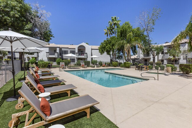 Chic poolside retreat with lounge chairs and umbrellas, right outside our building - Boulders at Lookout Mountain Apartment Homes