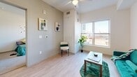 Located at 919 Alcott Way in Denver, Colorado, this well-designed one-bedroom, one-bathroom residence offers a thoughtful layout with modern finishes throughout. The open-concept living area seamlessly connects the kitchen, dining, and living spaces, creating an efficient and welcoming environment. Light wood-look flooring runs through the main living areas, complementing the bright, neutral color palette.

The kitchen is a standout feature, equipped with grey shaker-style cabinetry extending to the ceiling, stainless steel appliances including a refrigerator, range, microwave, and dishwasher, and a white quartz-topped island that doubles as a dining and prep space. Recessed lighting and under-cabinet illumination enhance the clean, contemporary aesthetic.

The living area benefits from large windows that invite ample natural light and offer outdoor views, along with a ceiling fan overhead. The bedroom is a comfortable retreat, featuring plush carpeting, a dedicated closet, and a window with exterior views.

The bathroom is finished with white subway tile surrounding a full soaking tub and shower combination, wood-look flooring, and a clean white vanity. Throughout the residence, the design prioritizes functionality and a bright, modern ambiance, making it an attractive option in the Denver, CO area.