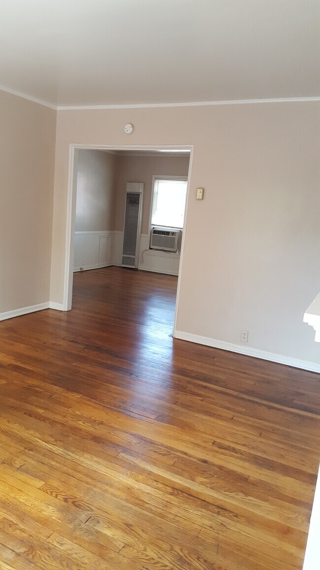 living room looking into dining area - 101 E 21st St