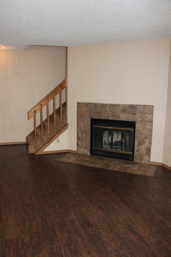 main living area with wood burning fireplace - 6469 McNichols Ct