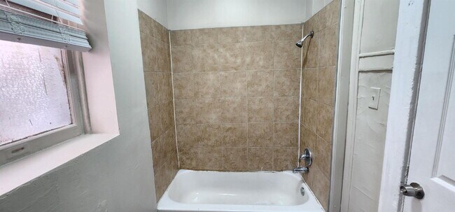 Building Photo - Spacious First-Floor 2BR with Bonus Room & Updated Interior – Pet Friendly!