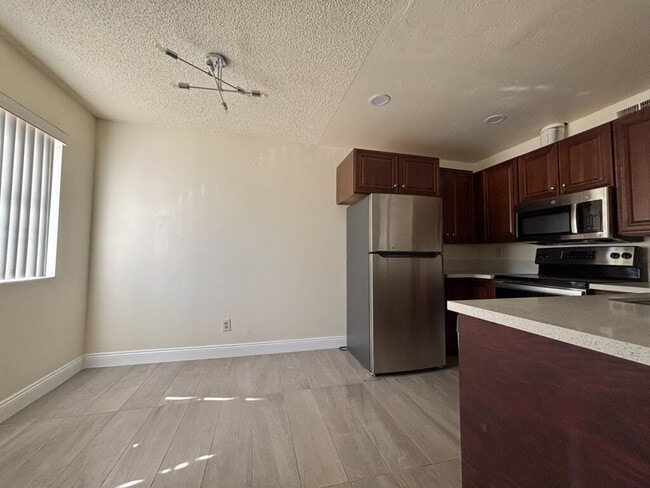 Building Photo - Downstairs 2BR/1BA—recently updated with new flooring, new countertops, and clean, neutral finishes.