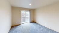 This well-appointed two-bedroom, two-bathroom residence in Auburn, WA offers a comfortable and functional layout across a single floor. The open living room features smooth hardwood-style flooring and is bathed in natural light, with sliding glass doors opening onto a private balcony that overlooks lush greenery — an inviting space for relaxing or entertaining. The kitchen is efficiently designed with light wood cabinetry, ample counter space, and black appliances including a refrigerator, range, microwave, and dishwasher. The primary bedroom is generously sized, featuring plush carpeting, a sliding glass door to a second balcony access point, and a spacious closet with built-in shelving. The second bedroom also features carpet flooring and a sliding closet with rod and shelf storage. Both bathrooms are thoughtfully finished, with one showcasing a soaking tub with tile surround, herringbone-patterned vinyl flooring, and wood-toned cabinetry. A dedicated in-unit laundry room adds everyday convenience. Throughout the home, warm neutral tones and clean lines create a calm, welcoming ambiance, making this Auburn residence a practical and comfortable place to call home.
