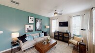 This single-story, two-bedroom, two-bathroom residence offers a well-organized layout that balances comfort and functionality. The living room serves as the focal point of the home, featuring a bold teal accent wall adorned with framed artwork, wood-look flooring, a ceiling fan with integrated lighting, and multiple windows fitted with blinds and sheer curtains that allow ample natural light. A dedicated dining nook adjacent to the kitchen provides a cozy space for everyday meals, highlighted by a window with an outdoor view.

The kitchen is equipped with light wood cabinetry, granite-style countertops, stainless steel appliances, and wood-look flooring, creating a clean and functional workspace. Both bedrooms offer carpeted floors, natural light through window treatments, and sufficient space for full furniture arrangements. The primary bedroom connects to a bathroom featuring granite-topped vanity cabinetry, a tub-shower combination, wood-look flooring, and access to a walk-in closet with built-in shelving. The second full bathroom mirrors similar finishes, including a generous vanity with extended countertop space and a tub-shower combination, providing convenient access for guests or additional occupants.