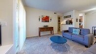Located at 3420 S Coulter St in Amarillo, Texas, this single-floor residence offers a well-organized layout designed for comfortable everyday living. The living room serves as the heart of the home, featuring plush carpeting, neutral walls, and a welcoming atmosphere with ample space for seating and relaxation. A pass-through opening connects the living area to the kitchen, enhancing the open feel between spaces. The galley-style kitchen is efficiently designed with warm wood cabinetry, dark countertops, wood-look flooring, and black appliances including a refrigerator, range, and microwave. Adjacent to the kitchen, a dedicated dining area with wood-look flooring and a ceiling fan provides a comfortable space for meals. The two bedrooms are carpeted and offer natural light through windows dressed with sheer curtains. Each bedroom includes closet storage, and the primary bedroom benefits from a generously sized walk-in closet outfitted with multiple shelving units and hanging rods. The bathroom features wood-look flooring and a shower-tub combination. Throughout the residence, textured ceilings and consistent neutral tones create a cohesive and practical living environment.