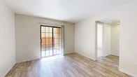 Located at 900 Country Club Dr SE in Rio Rancho, New Mexico, this single-floor, 2-bedroom, 4-bathroom residence offers a functional and well-organized layout. The open-concept living and kitchen area serves as the heart of the home, featuring light wood-look flooring, a ceiling fan, and a sliding glass door that fills the space with natural light and provides direct access to a private patio. The galley-style kitchen is equipped with wood-trimmed cabinetry, light countertops, black appliances including a gas range and refrigerator, and a double sink.

The two bedrooms offer a comfortable retreat, with the primary bedroom providing a generous amount of space. Both bedrooms feature neutral carpet, large windows that invite natural light, and access to closets. The four bathrooms are efficiently designed, each with wood-look flooring, vanities with under-cabinet storage, and tub/shower combinations with tiled surrounds.

Additional practical features include dedicated laundry and utility rooms, multiple hallways connecting the various spaces seamlessly, and three closets throughout for ample storage. The overall palette of warm neutrals and light tones creates a clean, inviting ambiance throughout this well-appointed Rio Rancho residence.