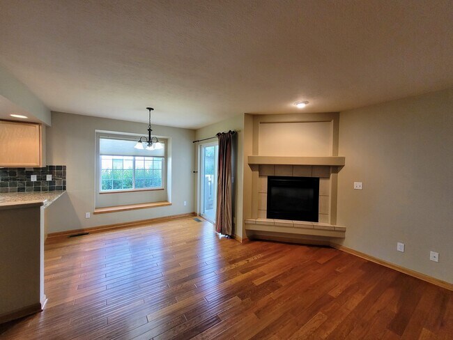 Wood floors in the spacious living room are complimented by a gas fireplace. - 4050 W Babcock St