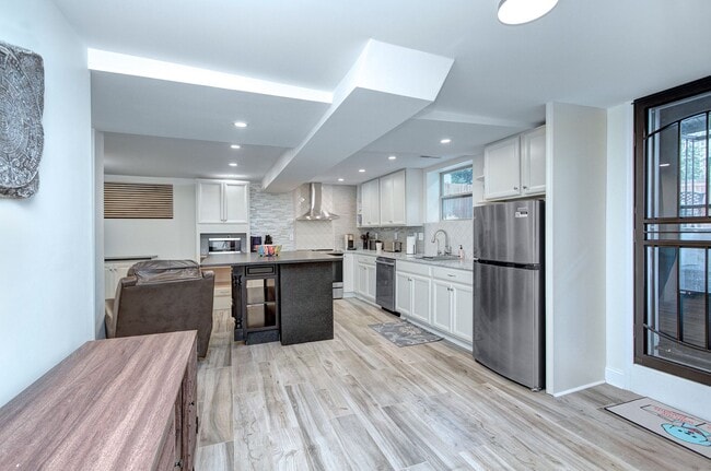 Building Photo - Discover the charm of this FULLY FURNISHED basement unit, tucked away in a beautifully updated bu...