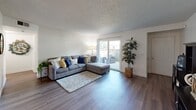 Located at 4498 N Cornelia Ave in Fresno, CA, this single-story, 2-bedroom, 1-bathroom unit offers a well-organized and functional layout. The living room is a welcoming space featuring wood-style flooring, a textured ceiling, and sliding glass doors that open to a private patio, allowing natural light to fill the room. Adjacent to the living room, the dining area includes a ceiling fan and a decorative round mirror, with an open sightline that connects seamlessly to the rest of the unit. The kitchen is equipped with warm wood cabinetry, a double-basin sink, a dishwasher, and a skylight-style overhead light fixture that brightens the workspace. The primary bedroom is a comfortable retreat with carpeted flooring, a window with outdoor views, and access to a dedicated closet. The second bedroom, also carpeted, features a window with natural light and serves well as a guest room or secondary use space. Both bedrooms are supported by a second closet offering additional storage. The full bathroom includes a tub-shower combination with a curved curtain rod and clean white finishes. A connecting hallway ties all rooms together, completing this practical and comfortable single-floor layout.