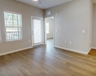This contemporary 950 square foot apartment in Kissimmee, FL, offers a harmonious blend of style and functionality. The heart of the home is a sleek, open-concept kitchen and living area, showcasing pristine white cabinetry, stainless steel appliances, and a striking light blue island that adds a pop of color. The kitchen's design is both practical and aesthetically pleasing, with ample counter space and modern pendant lighting.

The living area flows seamlessly from the kitchen, featuring warm wood-look flooring that extends throughout the apartment. Large windows in the bedrooms and living spaces flood the rooms with natural light, creating an airy and inviting atmosphere. The primary bedroom, measuring 180 square feet, provides a spacious retreat.

Both bathrooms are thoughtfully designed with clean lines, featuring modern vanities and ample storage. The apartment also includes two closets, offering plenty of storage options. Ceiling fans in the bedrooms provide additional comfort.

The overall design aesthetic is minimalist and contemporary, with a neutral color palette that allows for personal touches. This well-appointed apartment combines comfort and style, making it an ideal living space in the heart of Kissimmee.