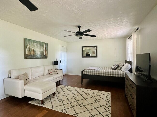 Living room/bedroom. Bed is a super comfy, top of the line mattress! - 947 Lake Dr