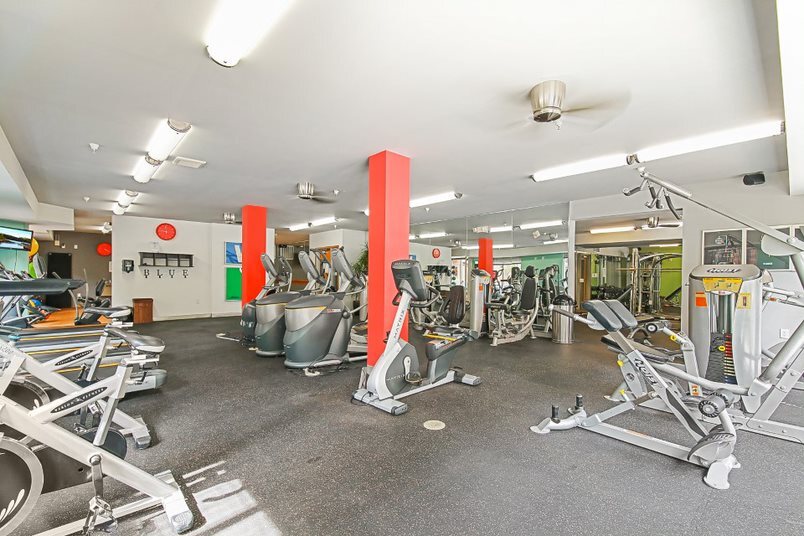 Fitness center with cardio machines and weight-lifting equipment.