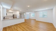 Located at 1024 Romneya Dr in Anaheim, California, this single-story home offers four bedrooms and two bathrooms thoughtfully arranged across a comfortable and functional floor plan. The living room welcomes residents with warm light wood-look flooring, recessed lighting, and large windows fitted with blinds that invite natural light while maintaining privacy. A sliding glass door provides access to the outdoors, enhancing the open feel of the space.

The kitchen is a standout feature, showcasing white shaker-style cabinetry, subway tile backsplash, light gray countertops, and a full suite of stainless steel appliances including a French door refrigerator, range, and microwave. A kitchen island with a built-in sink adds functionality and a natural gathering point.

The four bedrooms are carpeted in a neutral tone, offering a cozy feel, and are brightened by windows with blinds. The generously sized primary bedroom includes a walk-in closet equipped with multi-level shelving and hanging rods for ample storage. Both bathrooms are finished in clean, white tones — one featuring a tiled tub-shower combo and another with a glass-door walk-in shower, white vanity cabinetry, and wood-look flooring. The home's consistent use of crisp white walls and modern finishes lends a fresh, move-in-ready aesthetic throughout.