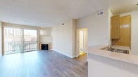 Located on Valley Spring Lane in North Hollywood, CA, this 3-bedroom, 2-bathroom single-floor home offers a well-organized and functional layout. The open living room is a standout, featuring light-toned hardwood-style flooring, a textured ceiling, and a marble-surround fireplace that serves as a focal point. A sliding glass door floods the space with natural light and opens to a private balcony with neighborhood views. The kitchen is positioned adjacent to the living area, featuring light wood cabinetry, light-toned countertops, a gas range, and tile flooring, offering a practical and efficient workspace. The three bedrooms are finished with plush carpeting and vertical blinds, providing comfort and privacy. Secondary bedrooms include mirrored sliding closet doors, while the primary bedroom benefits from its own walk-in closet with wrap-around shelving and hanging rods for generous storage. Two bathrooms serve the home, including one with a tub-shower combination enclosed by glass sliding doors, a single-sink vanity, and clean tile flooring. A hallway connects the rooms seamlessly, completing this efficiently designed home in a well-located North Hollywood neighborhood.