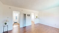 Located at 10800 Wright Road in South Gate, CA, this efficiently designed single-floor unit makes smart use of its space across a well-organized layout. Warm hardwood-style flooring runs throughout, complementing the clean white walls and textured ceilings that give each room a bright, cohesive feel.

The combined living and dining area serves as the heart of the unit, featuring a large picture window that invites abundant natural light and provides views of the surrounding community. A wall-mounted HVAC unit ensures year-round comfort, while the open layout allows for flexible furniture arrangements.

The kitchen is thoughtfully appointed with white cabinetry, granite-style countertops, a stainless steel gas range, and a double-basin sink positioned beneath a window with vertical blinds. Ample upper and lower cabinet storage makes this a highly functional cooking space.

The bathroom is clean and well-maintained, featuring a white vanity with a medicine cabinet mirror, updated brushed nickel fixtures, and a shower/tub combination. Three closets distributed throughout the unit provide generous storage capacity.

A hallway connects the main living areas to the private spaces, maintaining an efficient flow. The unit's bright, neutral palette and practical design make it a functional and comfortable living space in a convenient South Gate location.