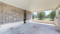 This single-level outdoor amenity facility serves as a dual-purpose car wash and pet wash station, thoughtfully designed for community use. The car wash area features a spacious covered bay with a durable concrete floor, brick accent walls, and an open side that allows natural light and fresh air to flow freely. A wall-mounted hose and utility connections are conveniently accessible, making vehicle cleaning straightforward and efficient.

Adjacent to the car wash, the Paw Spa pet wash station is enclosed by low-profile concrete block walls and accessed through a metal gate. The area is partially covered by a gabled roof supported by clean white columns, providing shade and shelter during use. At the center of the Paw Spa is a dedicated grooming tub equipped with a flexible wash hose, operating instructions, and safety signage — everything needed for a thorough pet wash.

A posted set of Paw Spa Rules ensures safe and respectful use of the space for all community members. The facility is set against a backdrop of lush green landscaping and open sky, creating a pleasant, well-maintained environment. Together, these amenities reflect a community-focused design that prioritizes convenience and practicality for both vehicles and pets.