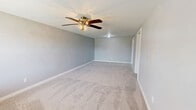 Located at 425 E 19th St in Panama City, Florida, this single-story, three-bedroom, one-bathroom home offers a practical and well-organized layout across its thoughtfully utilized floor plan. Neutral gray tones and clean white trim carry throughout the space, creating a cohesive and bright interior.

The kitchen is a standout feature, showcasing white shaker-style cabinetry, granite countertops, a tile floor in a stone-look pattern, and black appliances including a range, dishwasher, and refrigerator. The combined dining and living area provides an open gathering space connecting to the rest of the home.

Each of the three bedrooms is finished with plush carpeting and neutral wall tones. The primary bedroom is generously sized and includes a ceiling fan with light fixture. Two additional bedrooms feature natural light from windows with views of the outdoors, and one includes a built-in bench with storage beneath the window. Each bedroom benefits from dedicated closet space, with bifold closet doors providing ample storage.

The full bathroom is finished with tile flooring, a granite-top vanity, and a tub-shower combination. A dedicated laundry room with tile flooring and a water heater adds everyday convenience. Two hallways connect the rooms efficiently throughout the single-floor layout.