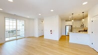 Located at 50 Kirby Ave in Somerville, NJ, this two-story, 2-bedroom, 2-bathroom home offers a thoughtfully designed layout across two floors. The main living level features an open-concept kitchen and living area bathed in natural light, with light-toned hardwood flooring throughout. The modern kitchen is outfitted with white shaker cabinets, a subway tile backsplash, stainless steel appliances, a peninsula with an undermount sink, and pendant lighting — combining both style and functionality. Sliding glass doors lead from the living area to a private balcony, enhancing the sense of openness. Carpeted stairs connect the levels, leading to two well-sized bedrooms, each with hardwood floors and ample natural light from large windows. The primary bedroom is generously proportioned with closet access and connects to the hallway. Both bathrooms feature floating navy-blue vanities with white countertops, modern black fixtures, and clean, contemporary finishes. A hallway ties the upper level together seamlessly. The ground floor includes an attached garage with direct interior access via a private entrance. Clean white walls, recessed lighting, and consistent finishes throughout give this home a bright, cohesive, and move-in-ready aesthetic.