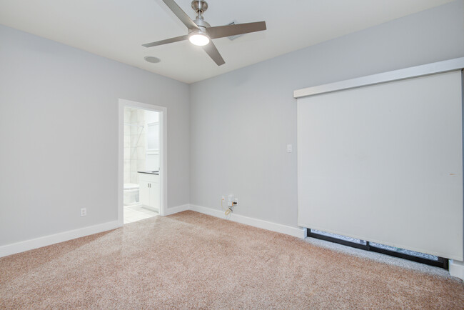 Spacious secondary bedroom with en-suite bathroom. Access to small gravel backyard (not pictured). - 4202 Spencer St