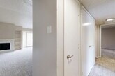 Located at 4208 W Pioneer Dr in Irving, TX, this single-story 2-bedroom, 3-bathroom home offers a well-organized layout across a comfortable footprint. The living room serves as a central gathering space, highlighted by vaulted ceilings, plush carpeting, a wood-burning fireplace, and built-in shelving. Natural light filters in through large windows fitted with blinds, enhancing the bright and open feel of the space. The adjacent dining area connects seamlessly to the galley-style kitchen, which features white cabinetry with sleek hardware, light quartz-style countertops, a tile backsplash, stainless steel appliances including a refrigerator and electric range, and wood-look flooring. The spacious primary bedroom benefits from a ceiling fan, natural light, and access to a generously sized walk-in closet with multi-level shelving and hanging rods. The second bedroom is similarly well-proportioned with its own ceiling fan and ample natural light. Three bathrooms serve the home, with at least one featuring a tiled tub-shower combination with safety grab bars. A dedicated laundry area, a central hallway, and four closets in total round out the practical and functional design of this home.