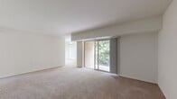 Located at 2000 Maplewood Dr in York, PA, this single-floor, three-bedroom, one-bathroom residence offers a practical and comfortable layout. The living area is bright and open, featuring neutral-toned carpeting and a sliding glass door that leads to a private balcony overlooking a lush, tree-lined backdrop — providing a peaceful, nature-filled setting. The entrance flows naturally into the main living space, which is bathed in natural light.

The generously sized primary bedroom offers ample room, highlighted by large windows with vertical blinds that allow soft, diffused light to fill the space. A built-in closet provides convenient storage. The additional bedrooms are similarly appointed with carpeted floors and bright windows.

The kitchen features updated grey cabinetry, marble-style countertops, light wood-look flooring, and black appliances including a full-size refrigerator — offering a modern, functional workspace. The full bathroom includes a tiled tub-shower combination in a clean, white finish.

A central hallway connects the bedrooms, bathroom, and two closets, ensuring efficient use of space. The balcony, framed by brick exterior walls and a metal railing, offers serene views of surrounding mature trees, adding a distinctive outdoor retreat to this well-organized residence.