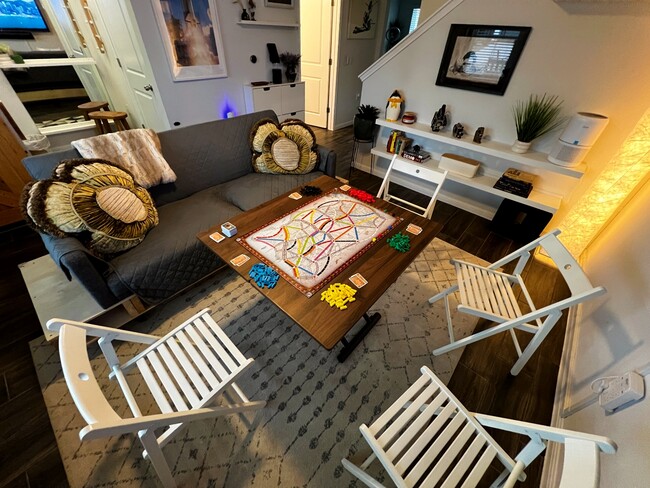 Transform the coffee table into a board game table with four extra folding chairs. - 9611 Morning Iris Dr